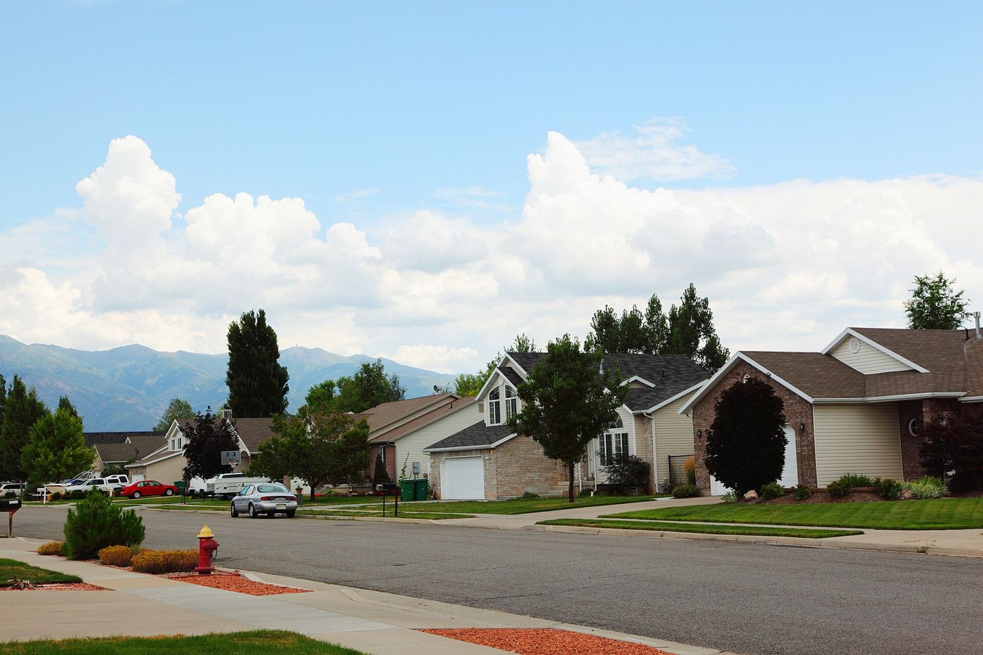 A residential street in Layton, Utah, with the mountains in the background